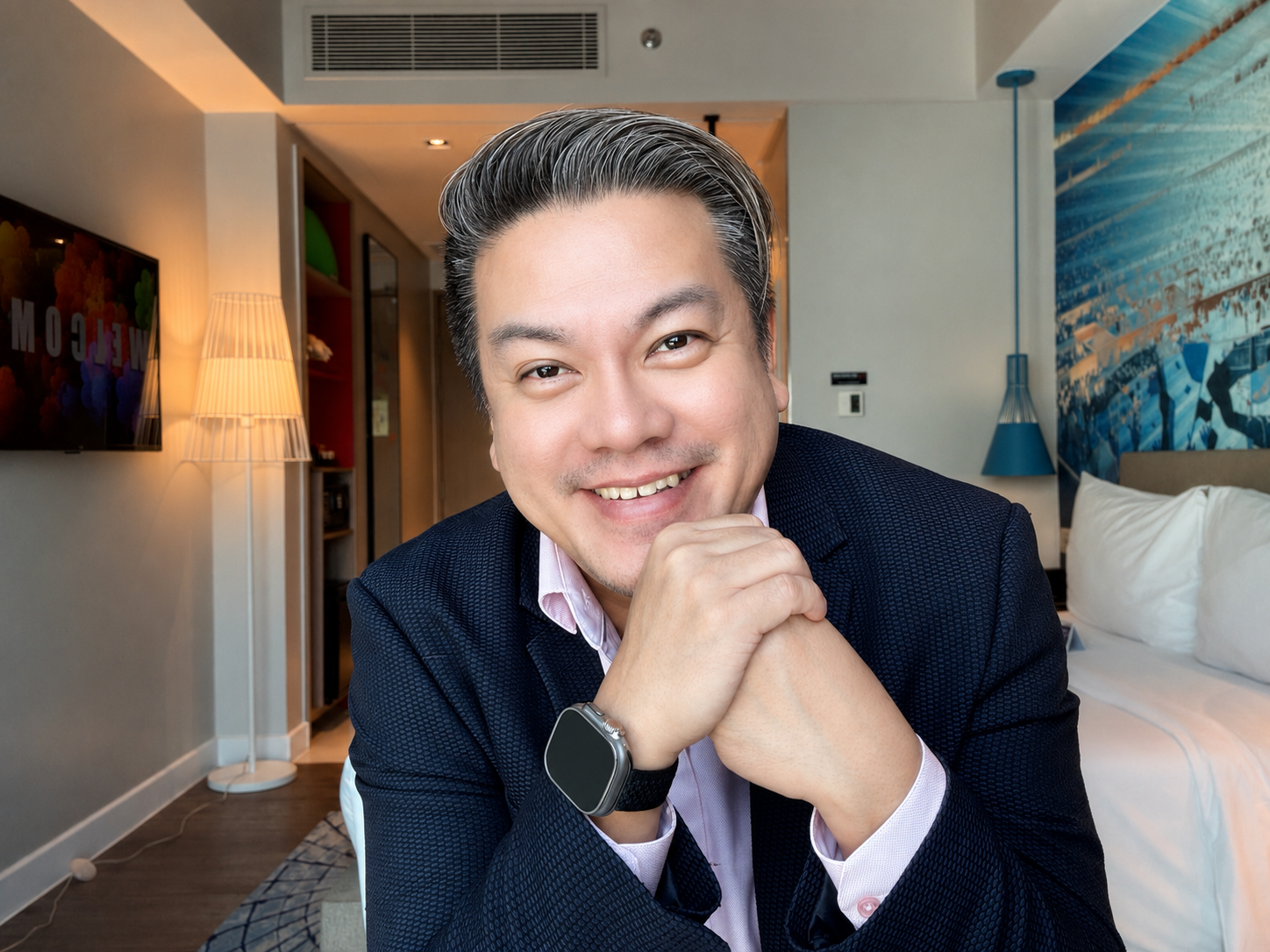 Portrait of Coach AJ dela Fuente smiling in a navy blazer