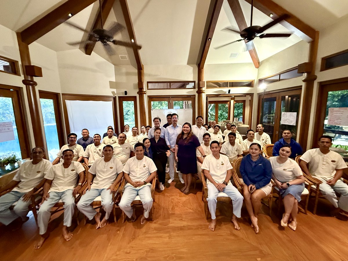 Team portrait inside a gathering space at Amanpulo